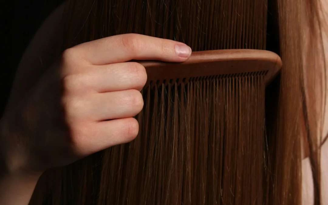 Professional hair brushes and combs on a salon counter at Kate’s Kuts Bonita Springs